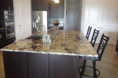 Example of a huge minimalist l-shaped ceramic tile eat-in kitchen design in Orlando with a single-bowl sink, raised-panel cabinets, dark wood cabinets, granite countertops, gray backsplash, ceramic backsplash, stainless steel appliances and an island