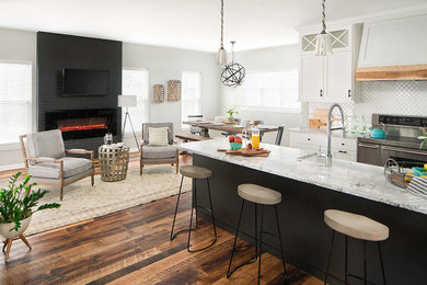 Huge transitional galley medium tone wood floor and brown floor eat-in kitchen photo in Columbus with a farmhouse sink, shaker cabinets, white cabinets, quartz countertops, white backsplash, ceramic backsplash, stainless steel appliances and an island