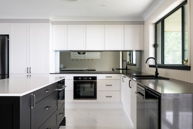 Modern kitchen in Newcastle - Maitland with mirror splashback and with island.