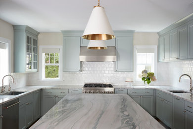 Eat-in kitchen - large transitional u-shaped medium tone wood floor and brown floor eat-in kitchen idea in New York with an undermount sink, shaker cabinets, green cabinets, quartzite countertops, white backsplash, ceramic backsplash, stainless steel appliances, an island and multicolored countertops