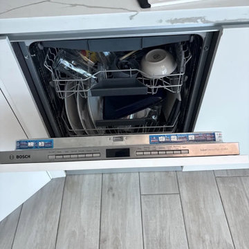 Dishwasher repair in Miami — built-in Bosch with the door open and a rack rail r