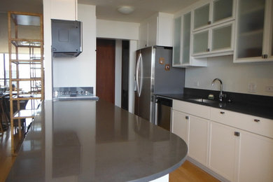 Kitchen pantry - mid-sized modern u-shaped light wood floor and brown floor kitchen pantry idea in Hawaii with an undermount sink, recessed-panel cabinets, white cabinets, quartzite countertops, white backsplash, stainless steel appliances, no island and gray countertops