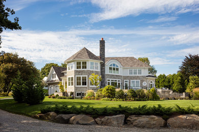 Elegant brown three-story mixed siding house exterior photo in Providence with a hip roof and a shingle roof