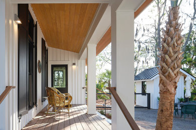 This is an example of a coastal side porch design in Charleston.