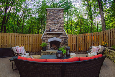 Photo of a mid-sized traditional backyard patio in Other with with fireplace, concrete slab and no cover.