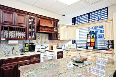Example of a classic kitchen design in New York with an undermount sink, raised-panel cabinets, granite countertops, stone slab backsplash, white appliances and an island