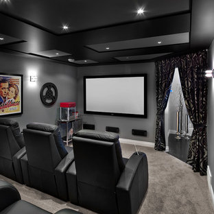 Home theater - transitional enclosed carpeted and gray floor home theater idea in Edmonton with gray walls and a wall-mounted tv