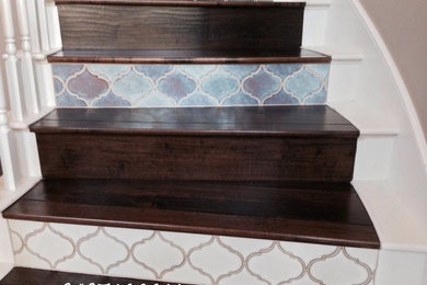 Inspiration for a large mediterranean wooden curved staircase remodel in Orange County with tile risers
