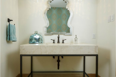Mid-sized transitional light wood floor and beige floor powder room photo in Ottawa with open cabinets, a wall-mount toilet, multicolored walls, a console sink and laminate countertops