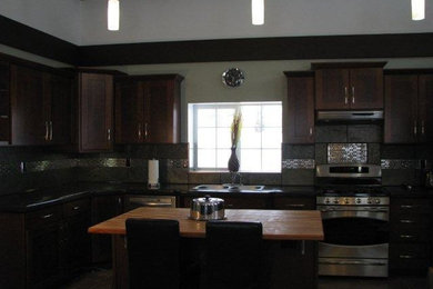 Example of a mid-sized transitional u-shaped ceramic tile eat-in kitchen design in Other with a drop-in sink, recessed-panel cabinets, dark wood cabinets, wood countertops, gray backsplash, ceramic backsplash, stainless steel appliances and an island