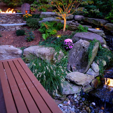 Alexandria Sloped Yard - Raised Patio, Fire Pit, & Water Feature