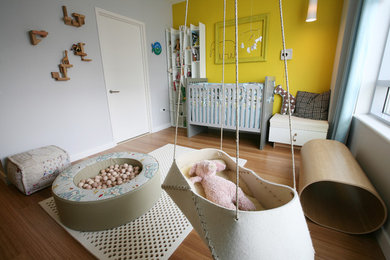 Contemporary gender-neutral kids' room in New York with beige walls.