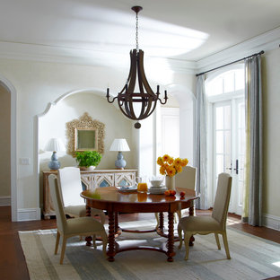 Inspiration for a timeless medium tone wood floor enclosed dining room remodel in Jacksonville with beige walls