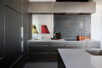 Example of a mid-sized trendy gray floor kitchen design in Phoenix with an undermount sink, flat-panel cabinets, an island and gray countertops