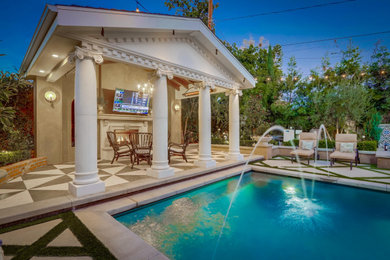 Example of a mid-sized classic backyard patio design in Orange County with a fireplace, decking and a gazebo