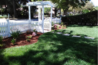 Photo of a mid-sized traditional partial sun front yard brick landscaping in San Francisco.