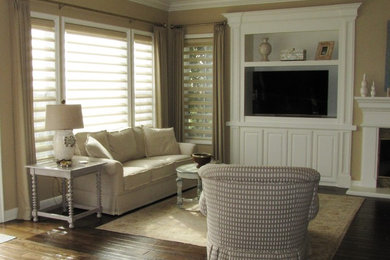 Mid-sized transitional formal and enclosed dark wood floor living room photo in San Diego with beige walls, a standard fireplace, a wood fireplace surround and a media wall