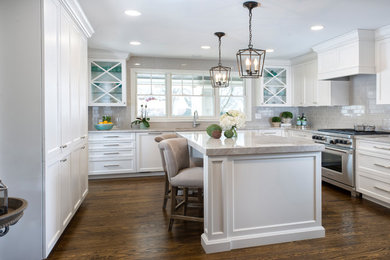 Eat-in kitchen - mid-sized transitional medium tone wood floor eat-in kitchen idea in Detroit with a single-bowl sink, shaker cabinets, white cabinets, quartzite countertops, gray backsplash, subway tile backsplash, paneled appliances and an island