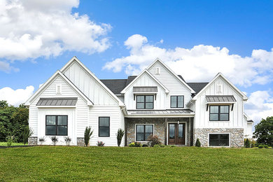 Example of a huge farmhouse white two-story mixed siding exterior home design in Other with a mixed material roof