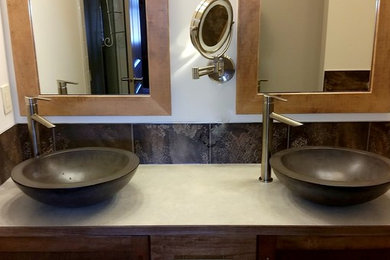 Bathroom - small contemporary brown tile and ceramic tile bathroom idea in Calgary with medium tone wood cabinets, a one-piece toilet, white walls and laminate countertops