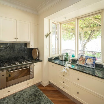 Country style kitchen with Verde Khater Granite Splash back and benches