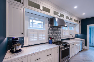 Example of a mid-sized arts and crafts galley porcelain tile and gray floor kitchen design in Atlanta with beaded inset cabinets, white cabinets, quartz countertops, porcelain backsplash, white countertops and blue backsplash