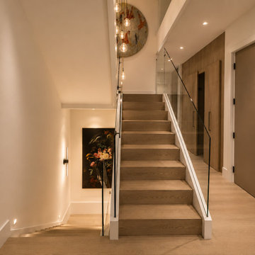 Modern Upper-Level Landing with Glass Stair Railing