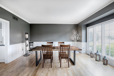 Example of a trendy light wood floor kitchen/dining room combo design in New York with gray walls and no fireplace