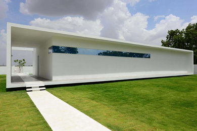 Inspiration for a large contemporary one-storey white house exterior in Hyderabad with a flat roof.