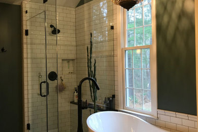 Example of a large transitional master porcelain tile, gray floor, double-sink and vaulted ceiling bathroom design in Other with shaker cabinets, light wood cabinets, a two-piece toilet, green walls, an undermount sink, marble countertops, a hinged shower door, white countertops and a built-in vanity