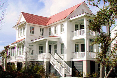 Inspiration for a mid-sized coastal white two-story wood exterior home remodel in Charleston with a metal roof