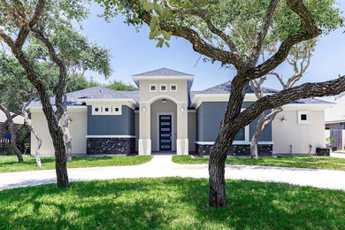 Large minimalist beige two-story mixed siding exterior home photo in Austin with a hip roof