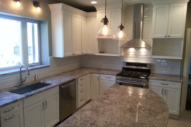 Eat-in kitchen - mid-sized transitional l-shaped porcelain tile eat-in kitchen idea in St Louis with an undermount sink, granite countertops, white backsplash, ceramic backsplash, stainless steel appliances and an island