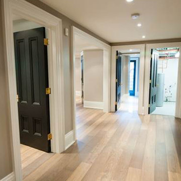 Custom Wood Floor, Black Interior Doors, White Baseboard Trim