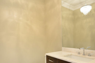 Powder room - transitional powder room idea in Chicago with marble countertops, beige walls, dark wood cabinets and recessed-panel cabinets