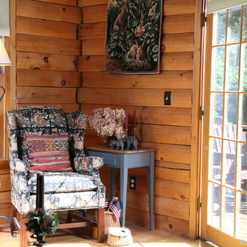 Custom cabin living room with view to log deck.