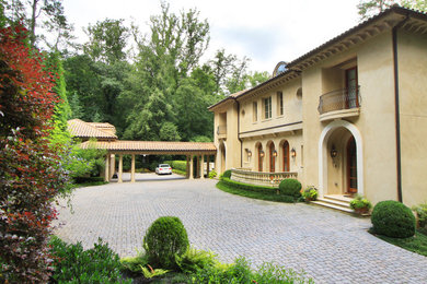 Large mediterranean yellow three-story stucco exterior home idea in Atlanta