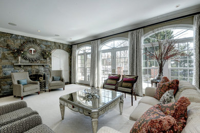 Large transitional formal carpeted and beige floor living room photo in DC Metro with gray walls, a two-sided fireplace, a stone fireplace and a concealed tv