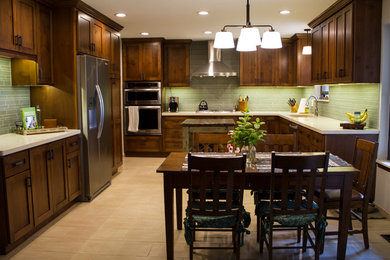 Mid-sized transitional porcelain tile eat-in kitchen photo in Oklahoma City with an undermount sink, flat-panel cabinets, medium tone wood cabinets, quartz countertops, green backsplash, glass tile backsplash, stainless steel appliances and an island