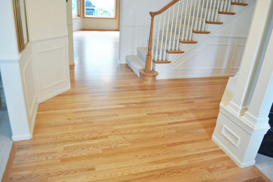 Design ideas for a mid-sized traditional hallway in Seattle with white walls, light hardwood floors and brown floor.