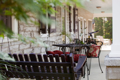 Large mountain style concrete porch photo in Los Angeles with a roof extension