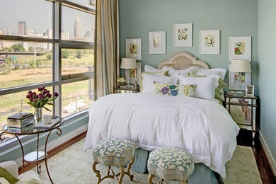 Elegant medium tone wood floor bedroom photo in Charlotte with blue walls