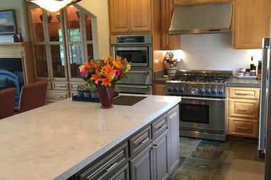 Large elegant l-shaped slate floor and gray floor open concept kitchen photo in San Francisco with an undermount sink, raised-panel cabinets, light wood cabinets, quartzite countertops, white backsplash, subway tile backsplash, stainless steel appliances, an island and beige countertops