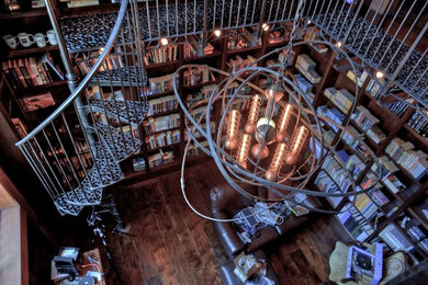 Inspiration for a large industrial freestanding desk dark wood floor home office library remodel in Other with brown walls