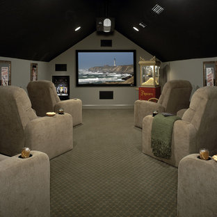 Example of a mid-sized classic enclosed carpeted and gray floor home theater design in Jacksonville with gray walls and a projector screen