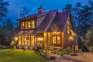 Mid-sized arts and crafts brown three-story wood exterior home photo in Charlotte with a shingle roof