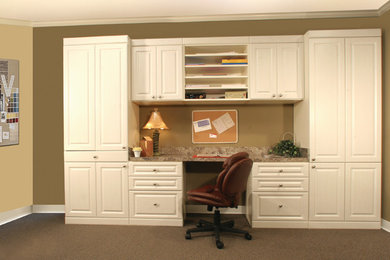 This is an example of a mid-sized traditional study room in Tampa with beige walls, carpet and a built-in desk.