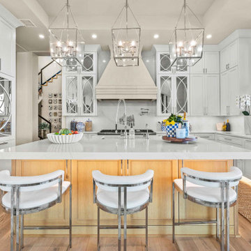 Kitchen Island with Mirrored Cabinetry and Range Hood