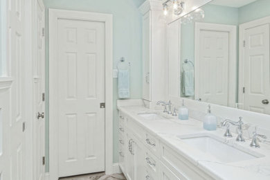 Example of a mid-sized transitional kids' white tile and ceramic tile ceramic tile, gray floor, double-sink and wainscoting tub/shower combo design in Philadelphia with shaker cabinets, white cabinets, a one-piece toilet, an undermount sink, quartzite countertops, white countertops, a niche and a built-in vanity