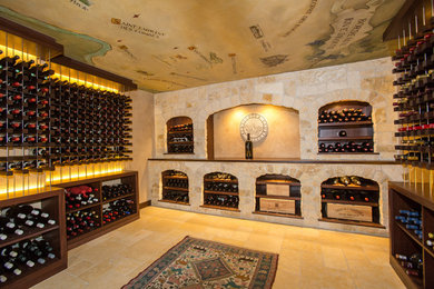 Design ideas for an expansive mediterranean wine cellar in Boston with limestone floors, storage racks and beige floor.